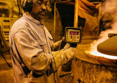 A foundry worker observes the laboratory-controlled melt process at Taylor & Fenn Company.